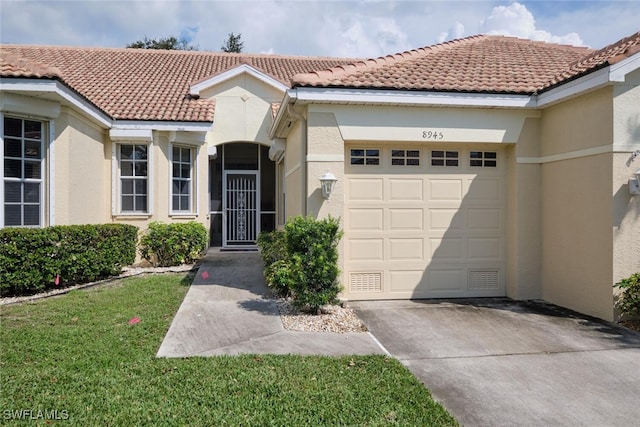 view of front of house with a garage and a front yard