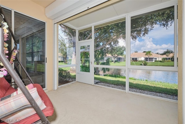 unfurnished sunroom with a water view