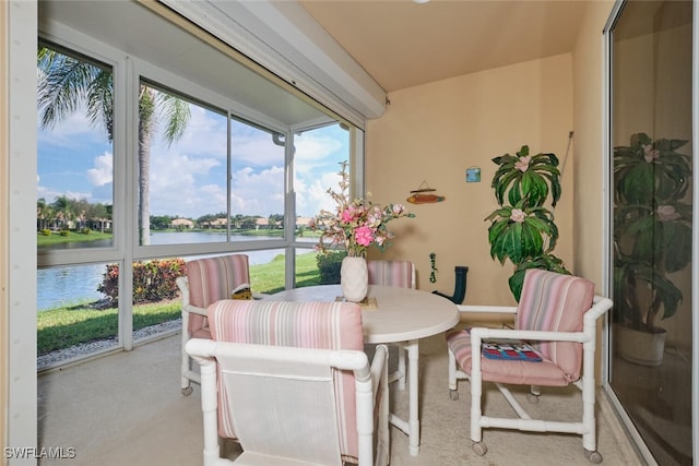 sunroom with plenty of natural light and a water view