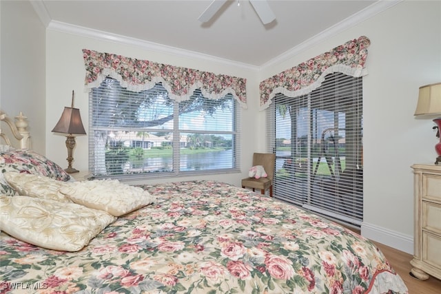 bedroom featuring ceiling fan, hardwood / wood-style floors, and crown molding