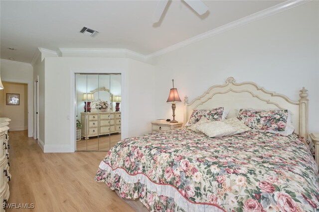 bedroom featuring crown molding, ceiling fan, a closet, and light hardwood / wood-style flooring