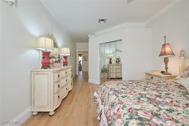 bedroom with ornamental molding and light hardwood / wood-style floors