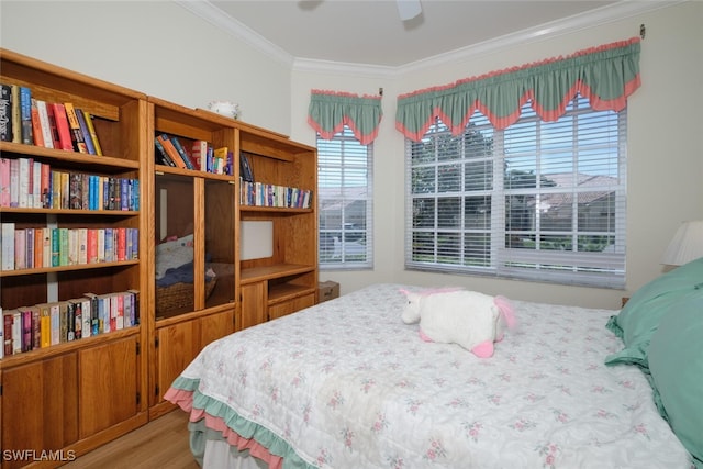 bedroom with ceiling fan, hardwood / wood-style flooring, and crown molding