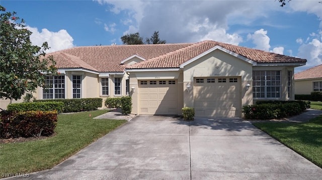 mediterranean / spanish house featuring a front lawn and a garage