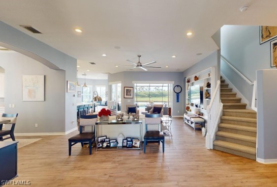 living room featuring light wood-type flooring and ceiling fan