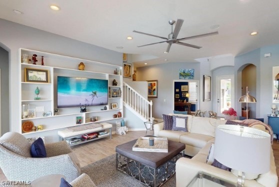 living room featuring ceiling fan and wood-type flooring