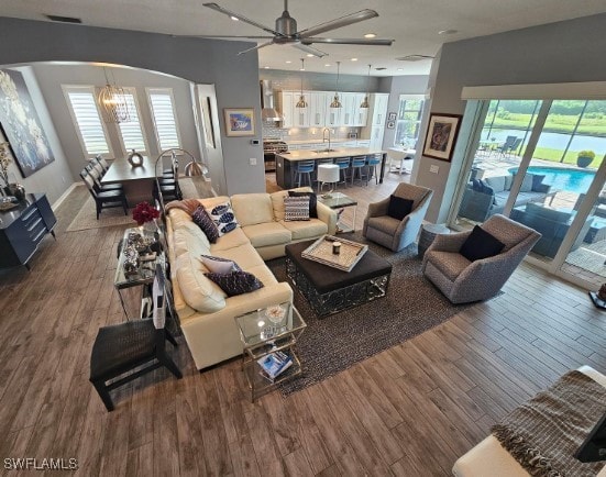 living room featuring hardwood / wood-style flooring, a wealth of natural light, and sink