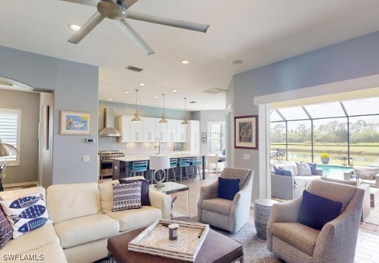 living room featuring sink and ceiling fan