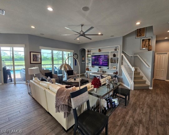 living room featuring ceiling fan and wood-type flooring