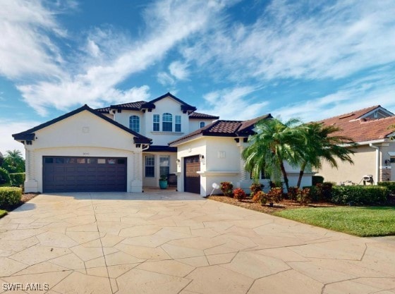 mediterranean / spanish home featuring a garage