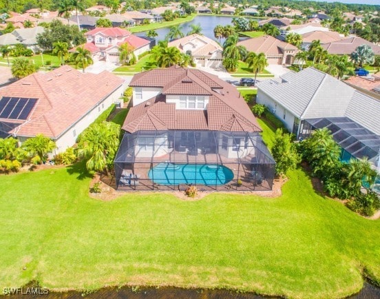 birds eye view of property with a water view