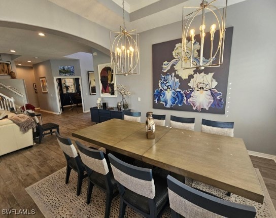 dining space featuring dark hardwood / wood-style floors and a chandelier