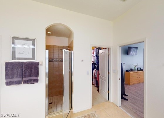 bathroom with tile patterned flooring and walk in shower