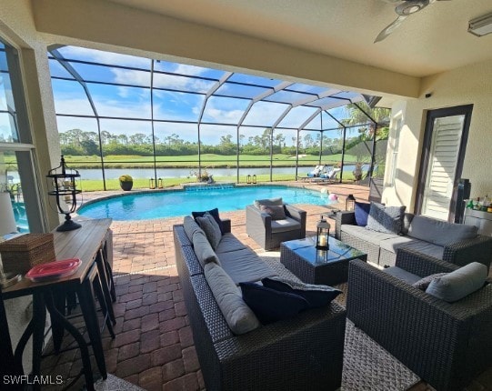 view of swimming pool with outdoor lounge area, a water view, glass enclosure, and ceiling fan