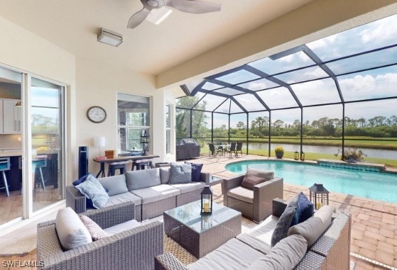 exterior space featuring outdoor lounge area, a water view, a lanai, and ceiling fan