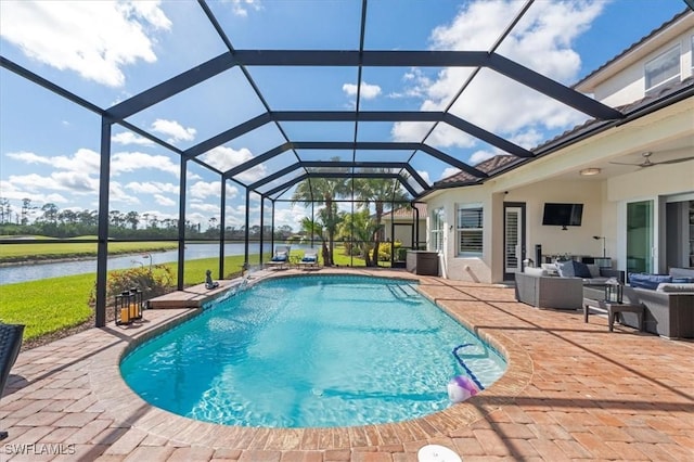 outdoor pool with outdoor lounge area, a water view, glass enclosure, a patio area, and ceiling fan