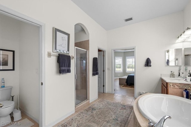 ensuite bathroom featuring toilet, vanity, visible vents, a shower stall, and a bath