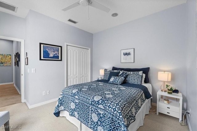 bedroom featuring carpet floors, a closet, visible vents, and baseboards