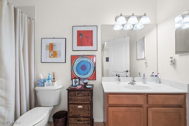 full bathroom featuring toilet and vanity