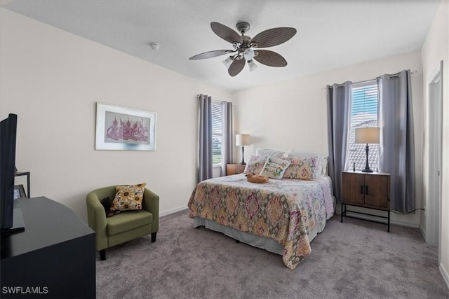 carpeted bedroom with ceiling fan and baseboards