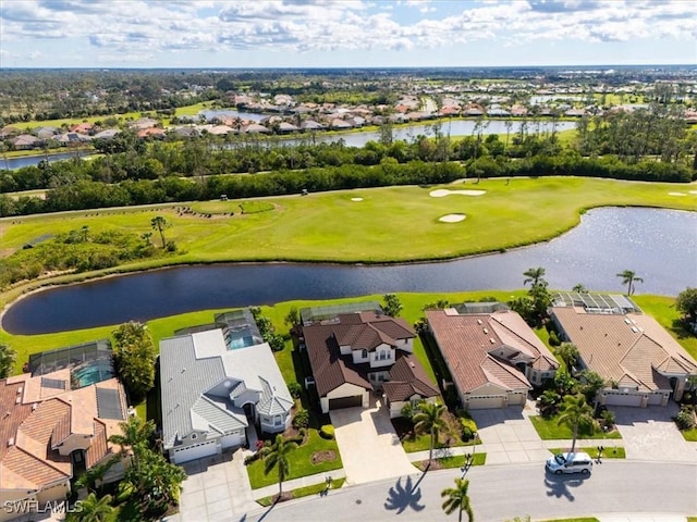 drone / aerial view featuring view of golf course, a water view, and a residential view