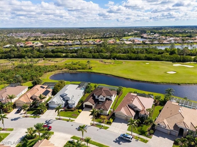 drone / aerial view with a water view, a residential view, and golf course view