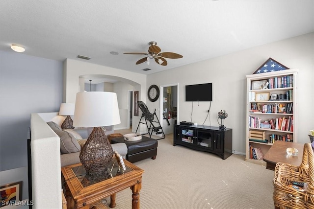 carpeted living room with visible vents and ceiling fan