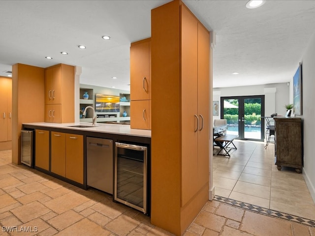 kitchen with beverage cooler, dishwasher, french doors, and sink