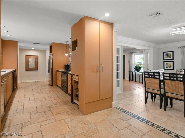 kitchen featuring stainless steel fridge and black range with electric stovetop