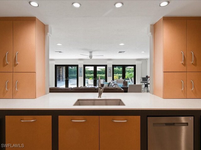 kitchen featuring ceiling fan, sink, french doors, and stainless steel dishwasher