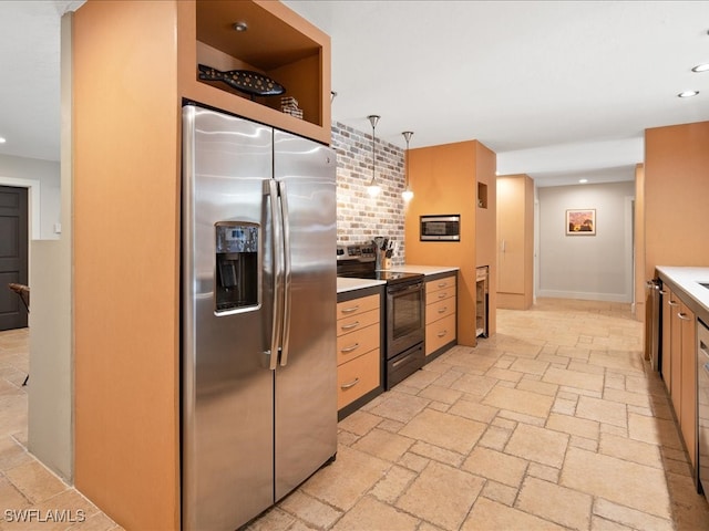 kitchen featuring light brown cabinets, hanging light fixtures, stainless steel fridge, backsplash, and electric range