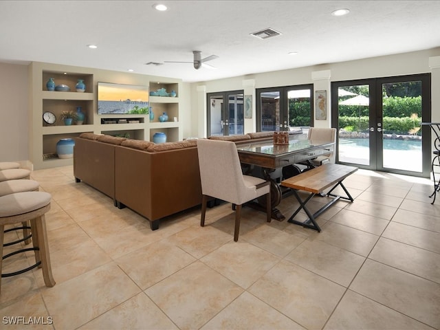 dining area with built in shelves, ceiling fan, light tile patterned flooring, and french doors