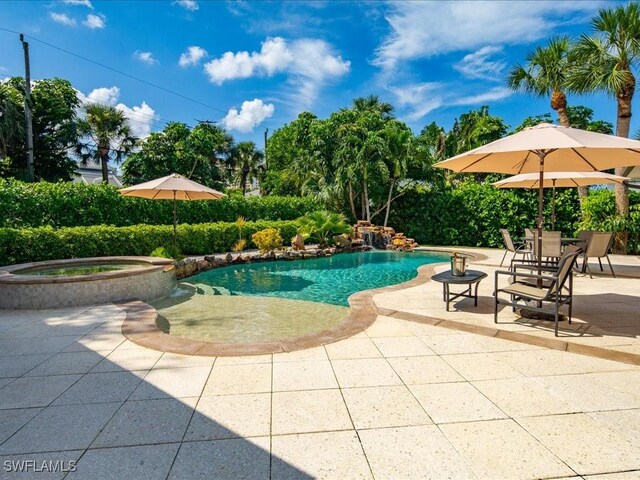 view of swimming pool with an in ground hot tub and a patio area