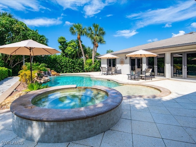 view of pool with an in ground hot tub and a patio area