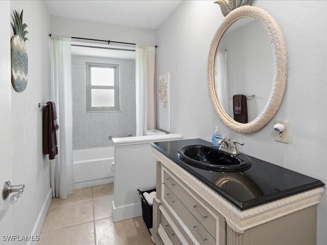 full bathroom featuring vanity, toilet, shower / bath combo with shower curtain, and tile patterned floors