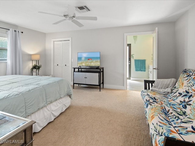 carpeted bedroom featuring ceiling fan and a closet