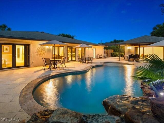 view of pool featuring a patio area and french doors