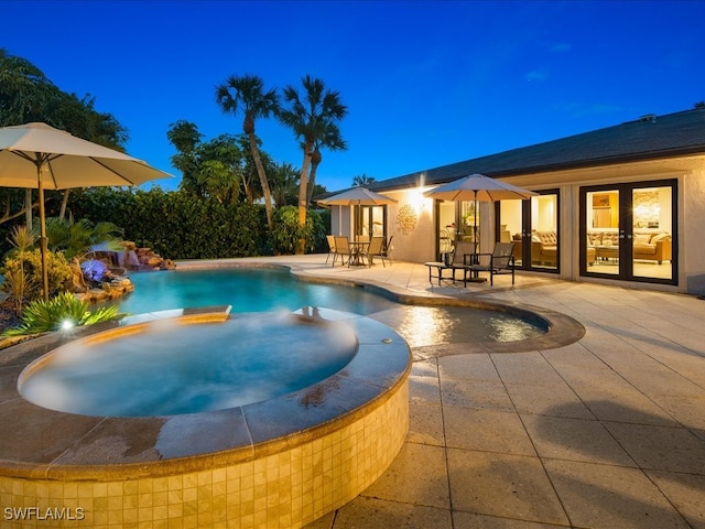 view of pool with an in ground hot tub and a patio area