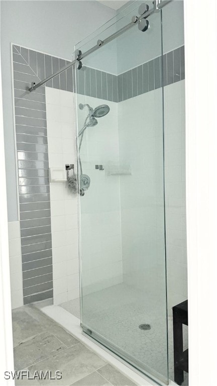 bathroom with a shower with door