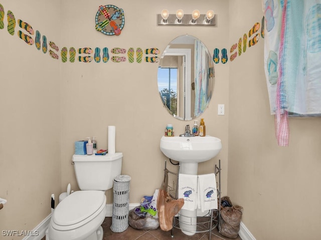 bathroom featuring toilet and tile patterned floors