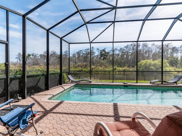 view of swimming pool with a patio and a lanai