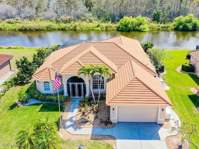 exterior space featuring a water view, a front yard, and a garage