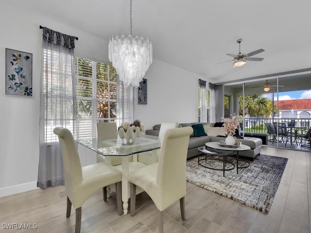 dining area with light hardwood / wood-style floors and ceiling fan with notable chandelier