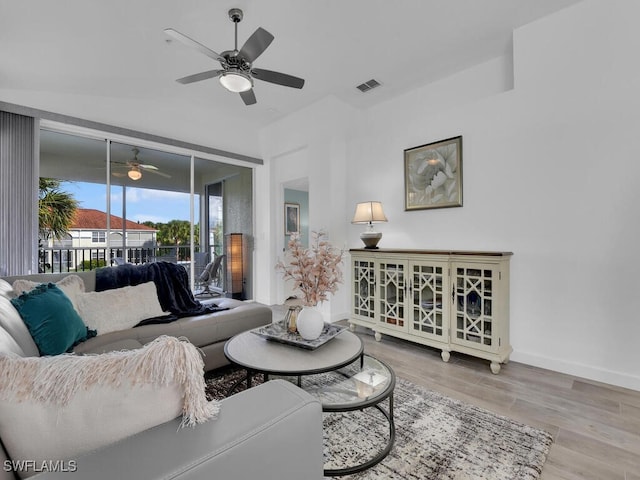 living room with light hardwood / wood-style floors and ceiling fan