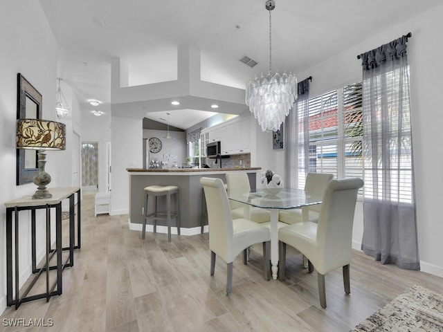 dining area featuring a chandelier and light hardwood / wood-style floors