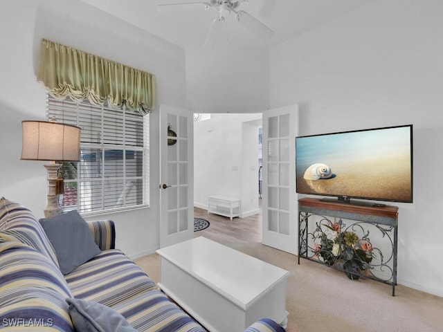 carpeted living room featuring french doors and ceiling fan