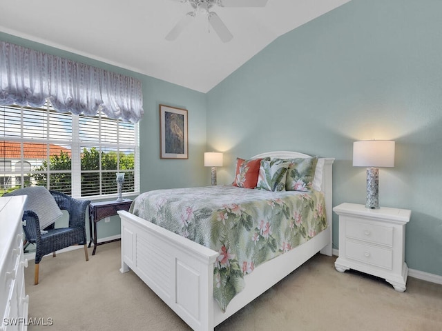 carpeted bedroom featuring vaulted ceiling and ceiling fan