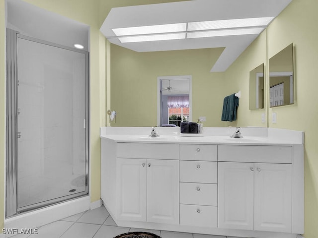 bathroom featuring a shower with door, vanity, and tile patterned floors