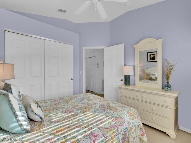 bedroom featuring lofted ceiling, light carpet, a closet, and ceiling fan