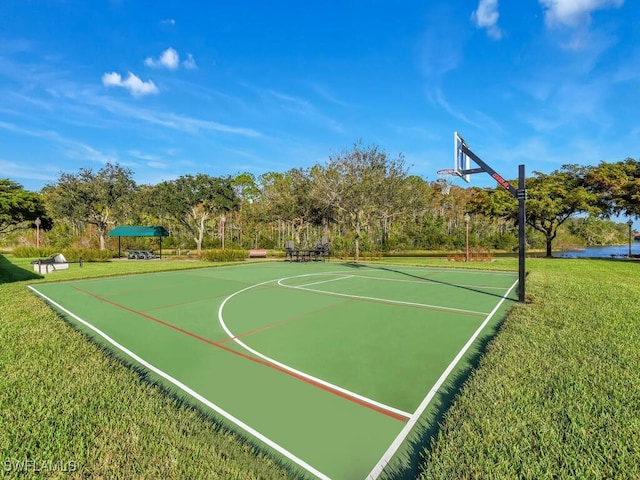 view of basketball court with a lawn